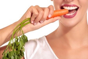 Woman eating a carrot